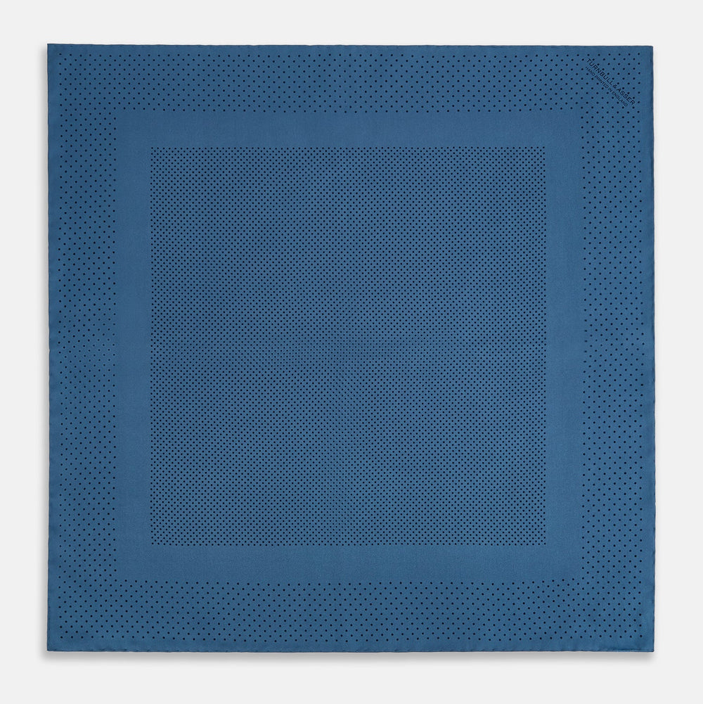 The Blue Dot Silk Pocket Square by Turnbull & Asser features small black polka dots on blue silk and is made in England. The image shows it neatly folded, with a corner turned down to display both sides.