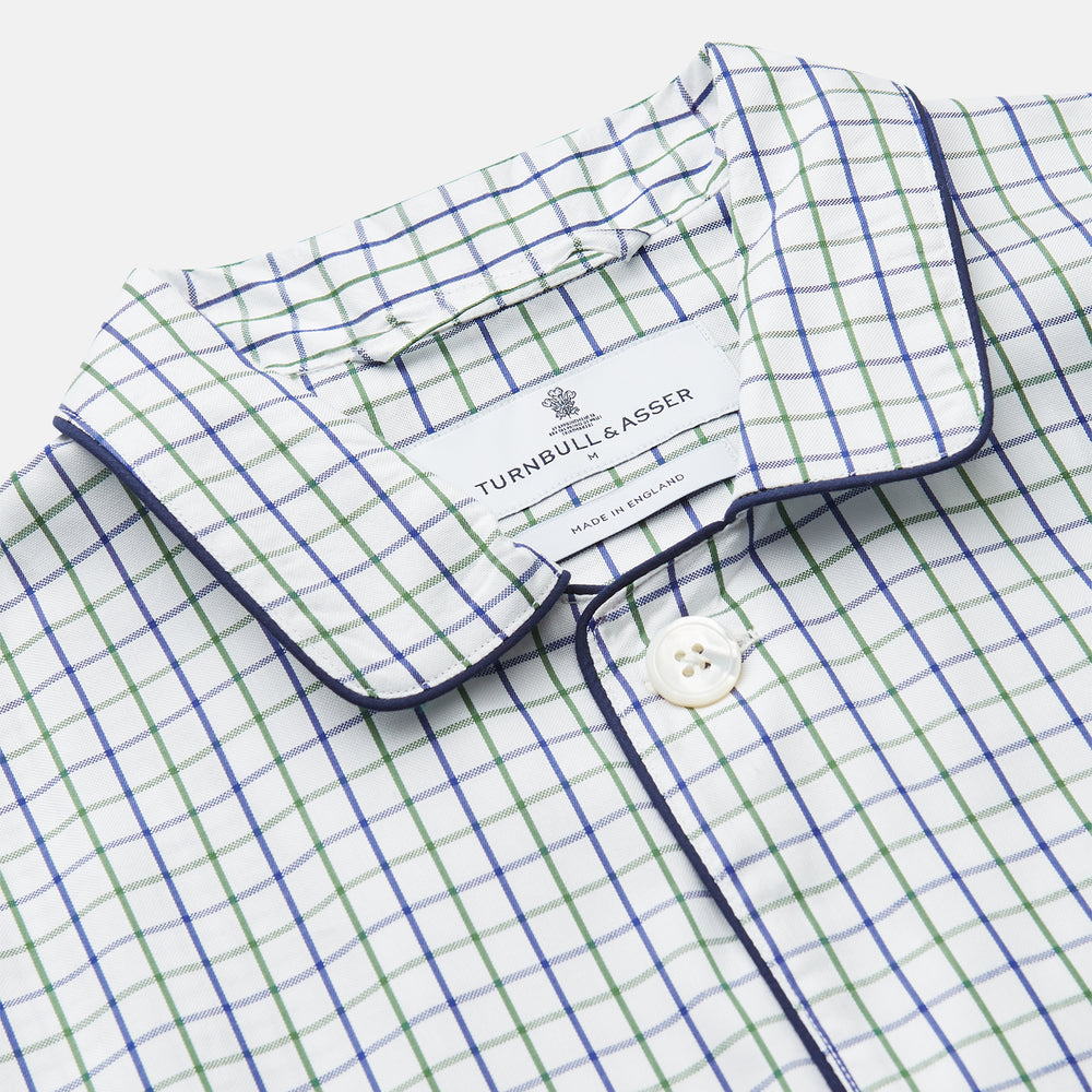 The Turnbull & Asser Green and Blue Check Cotton Hyde Pyjama Set for men features a long-sleeve, button-up top and pants with contrasting dark piping, shown laid flat on a white background.