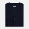 View 4 of product The Turnbull & Asser Navy Fine Merino V-Neck Cardigan features long sleeves, ribbed cuffs and hem, and is crafted from premium yarn for comfort and style, shown on a white background.