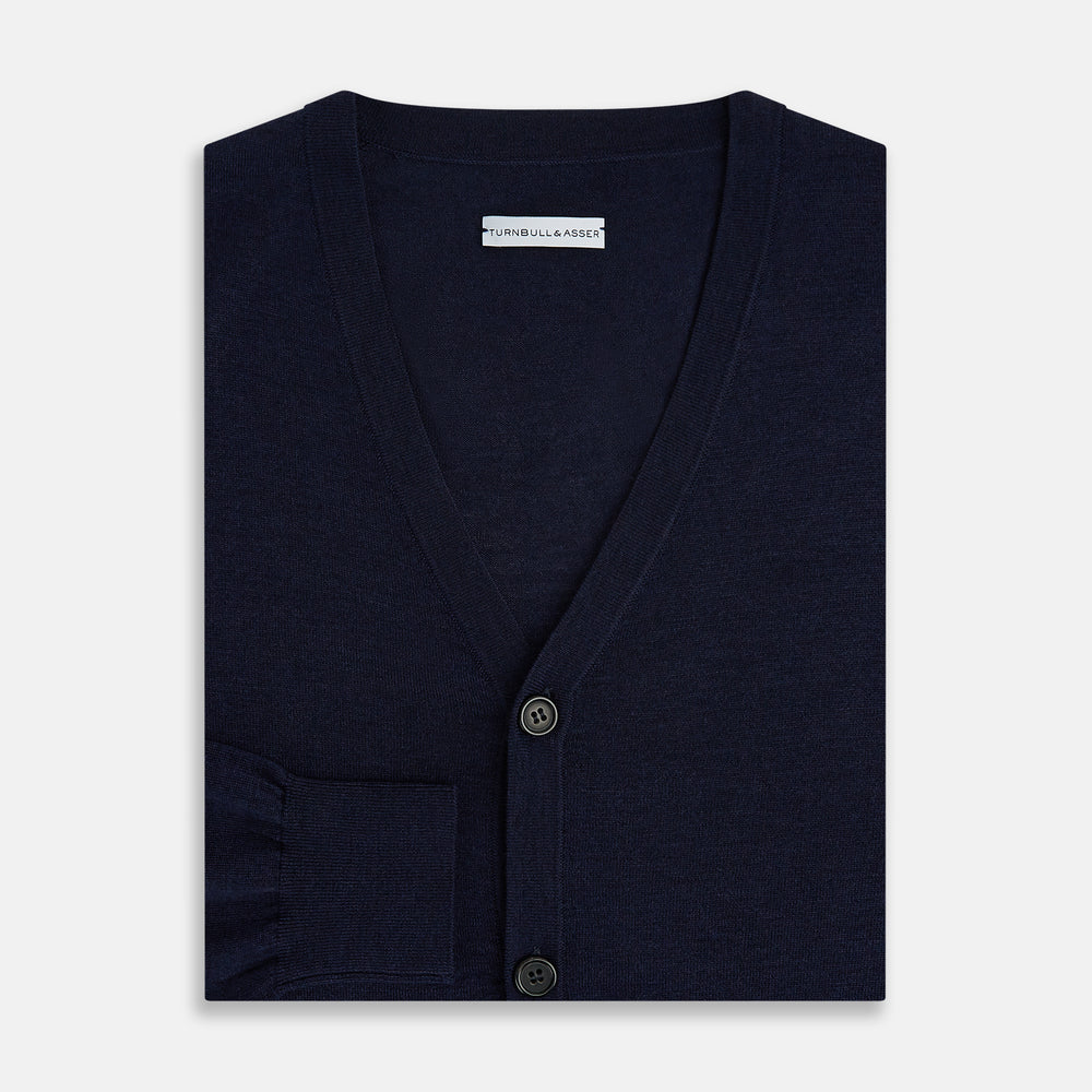 The Turnbull & Asser Navy Fine Merino V-Neck Cardigan features long sleeves, ribbed cuffs and hem, and is crafted from premium yarn for comfort and style, shown on a white background.