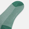 View 3 of product The Ivory/green Houndstooth Long Sock by Turnbull & Asser features a houndstooth pattern on the lower half with a solid green upper band, heel, and toe, shown against a white background.