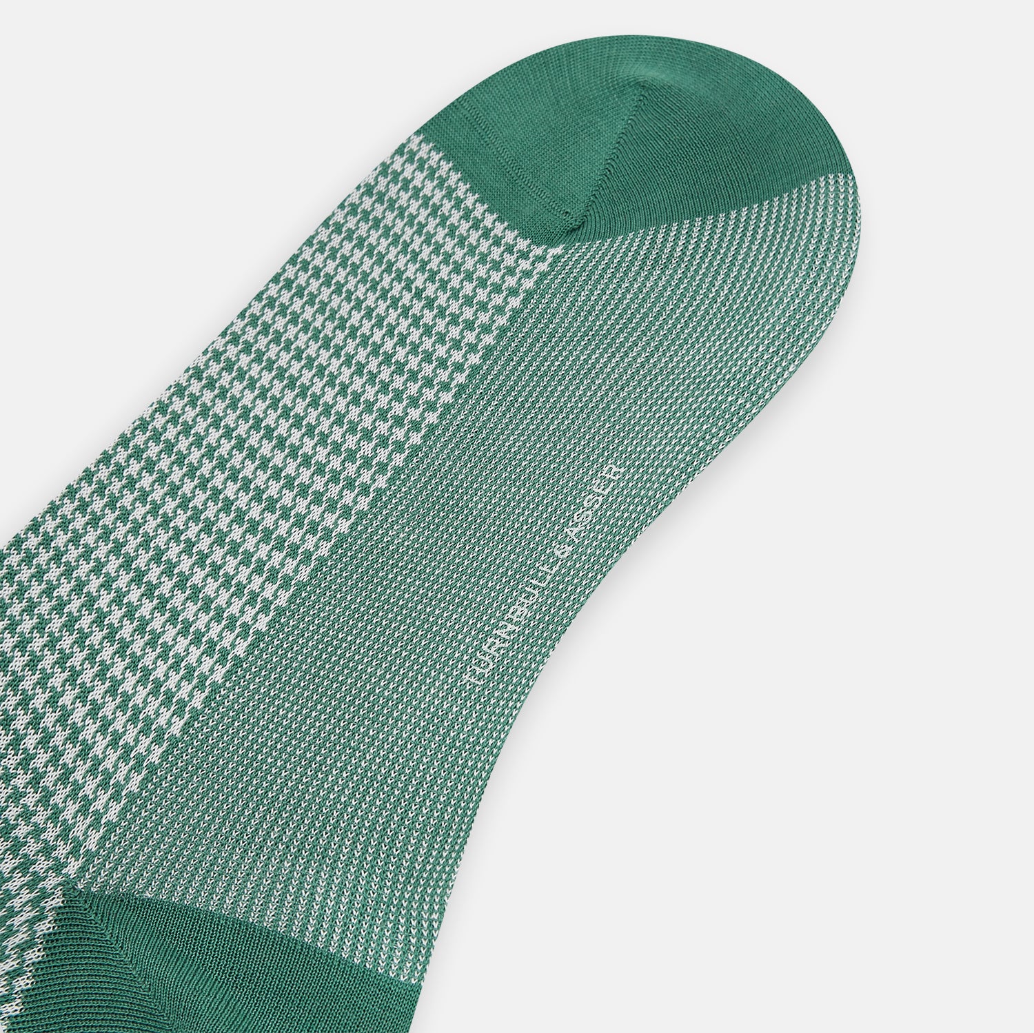 View 3 of product The Ivory/green Houndstooth Long Sock by Turnbull & Asser features a houndstooth pattern on the lower half with a solid green upper band, heel, and toe, shown against a white background.