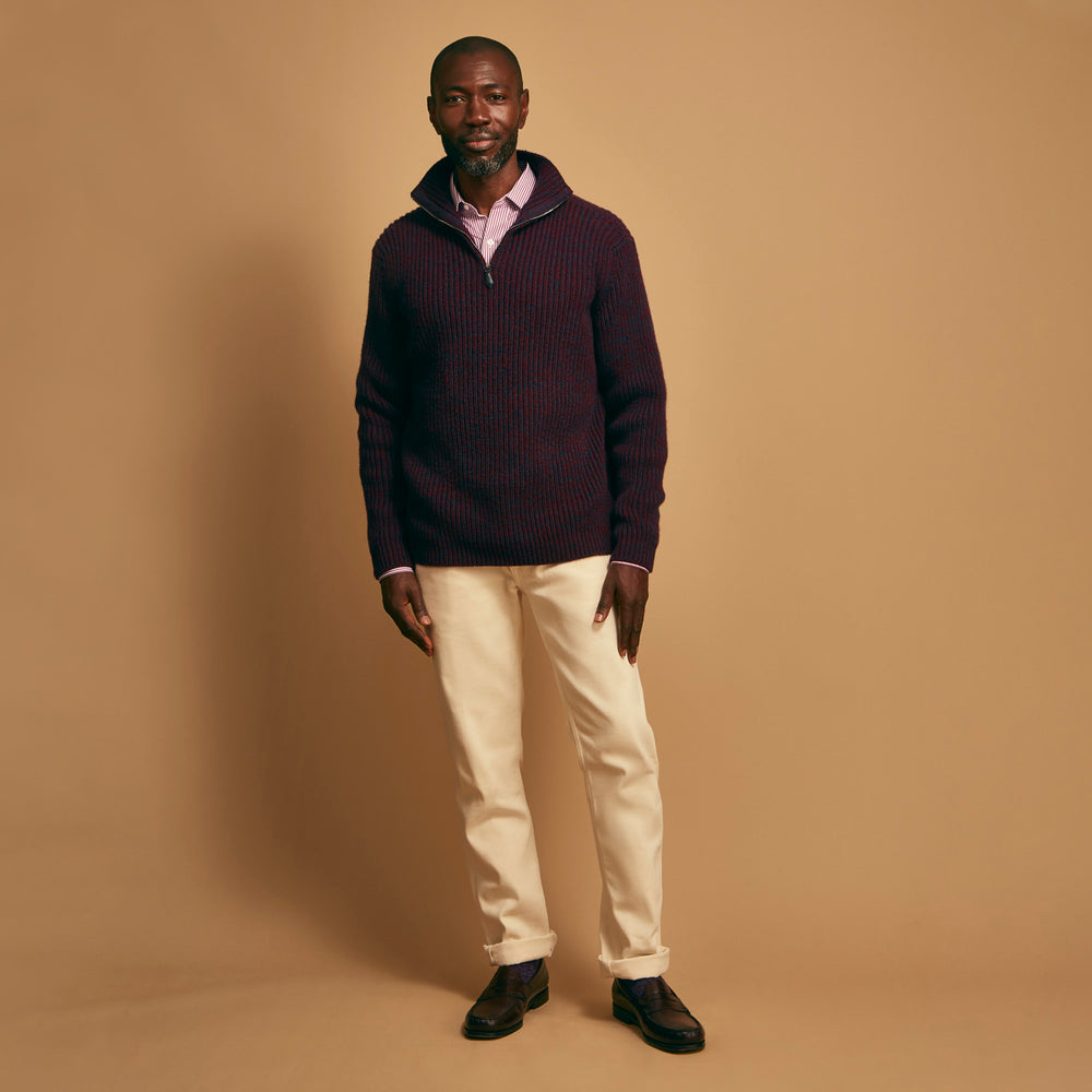 The Turnbull & Asser Burgundy Mullion Half Zip Rib Cashmere Jumper features a high collar and half-zip front in dark red and navy cashmere, shown laid flat on a white background—ideal for an elevated casual look.