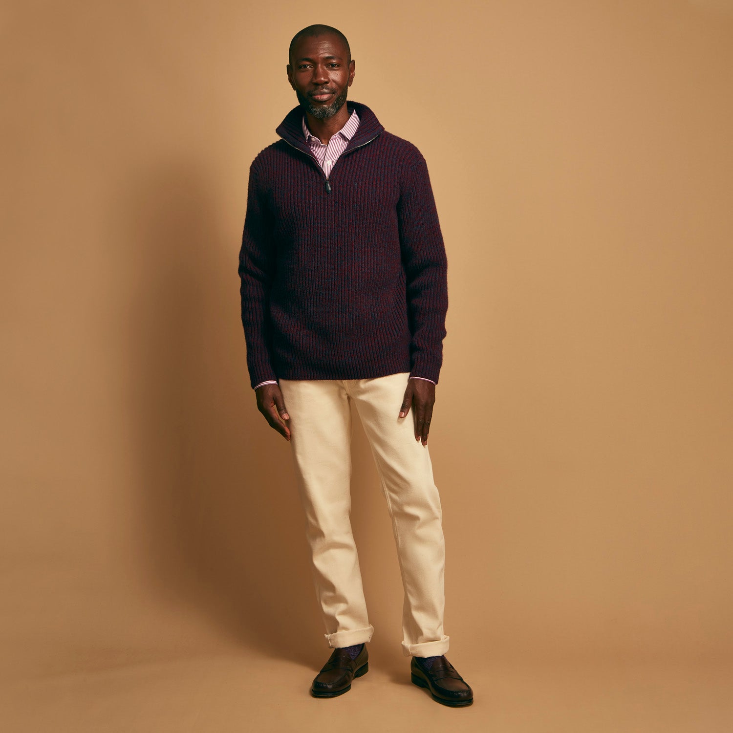 View 2 of product The Turnbull & Asser Burgundy Mullion Half Zip Rib Cashmere Jumper features a high collar and half-zip front in dark red and navy cashmere, shown laid flat on a white background—ideal for an elevated casual look.