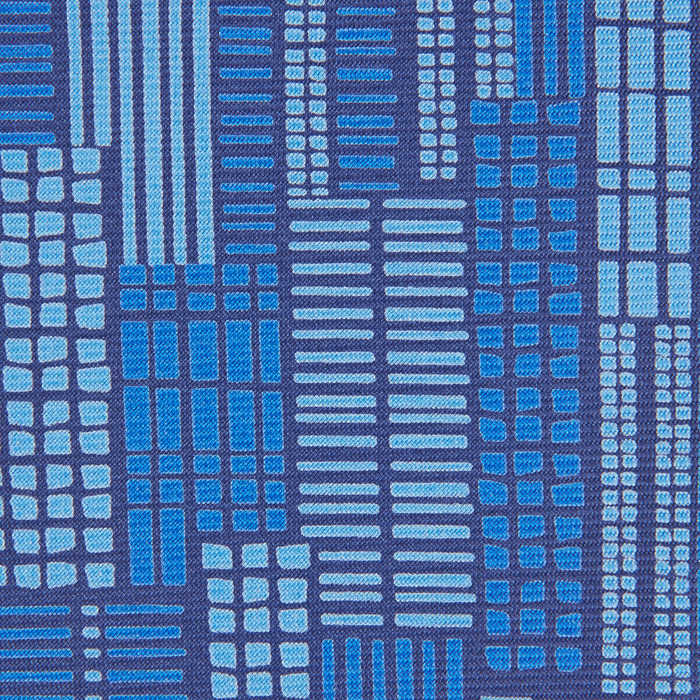 The Turnbull & Asser Blue Motif Printed Foulard Silk Tie showcases a geometric pattern in varying blue shades, making it a striking and essential accessory for any wardrobe.