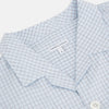 View 2 of product The Turnbull & Asser Blue Graph Check Pyjama Shirt features long sleeves, a collar, and a small check pattern in light blue—ideal as elegant loungewear.
