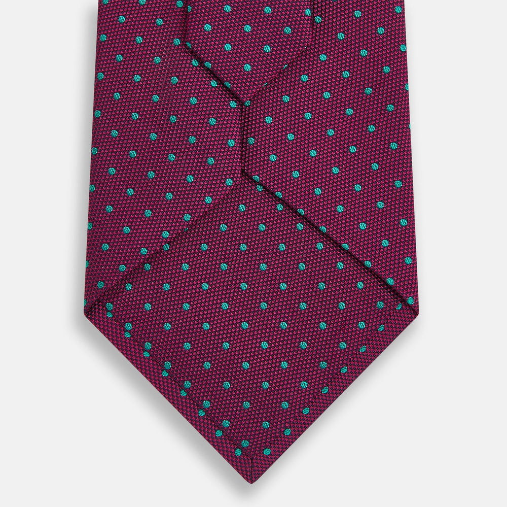 A smart accessory, the Antique Pink and Green Micro Dot Silk Tie by Turnbull & Asser is a striking spotted silk tie displayed on a white background.