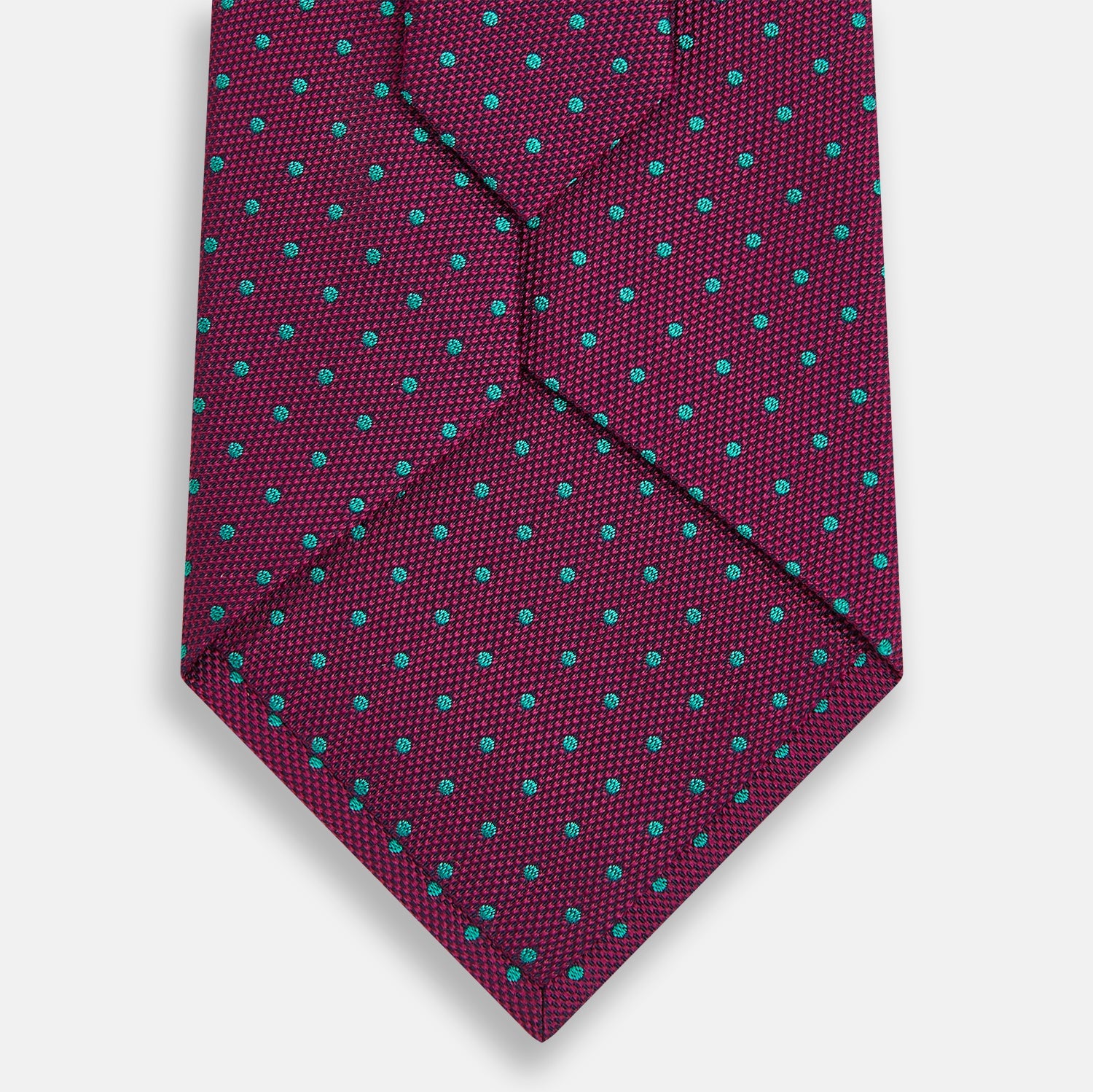 View 3 of product A smart accessory, the Antique Pink and Green Micro Dot Silk Tie by Turnbull & Asser is a striking spotted silk tie displayed on a white background.