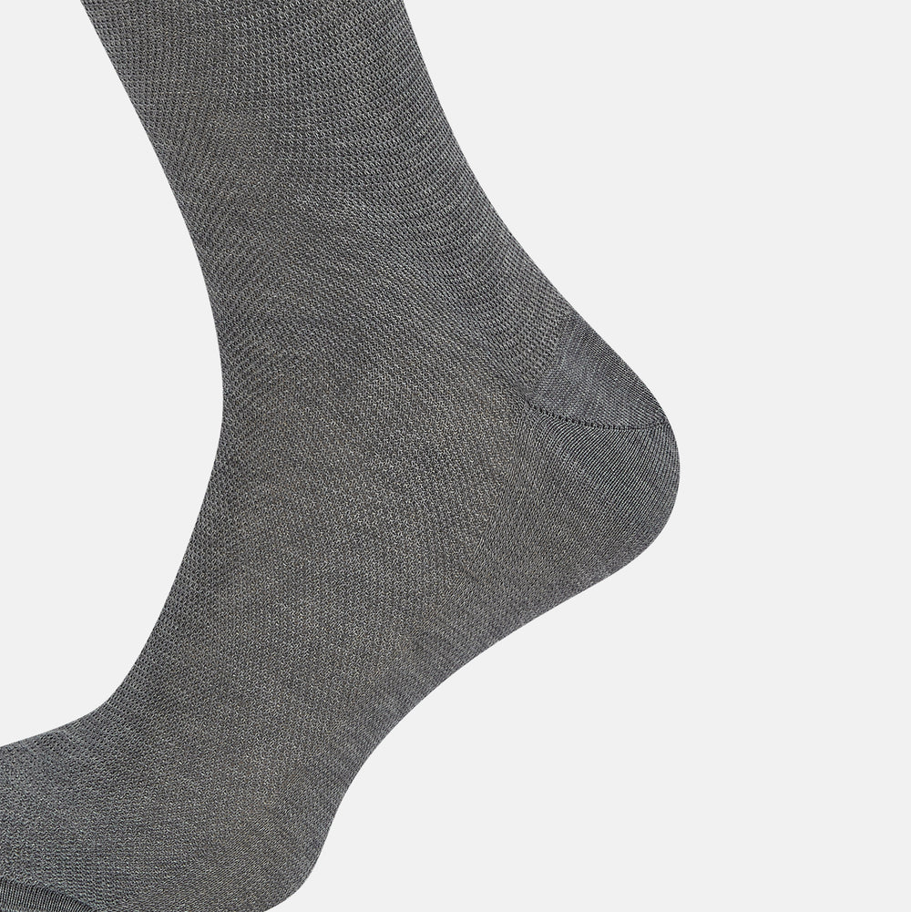 A single Steel Melange Micro Knit Mid-Length Sock by Turnbull & Asser, knee-high and gray, crafted from mercerised Egyptian cotton with a subtle micro knit pattern, is displayed upright on a plain white background.