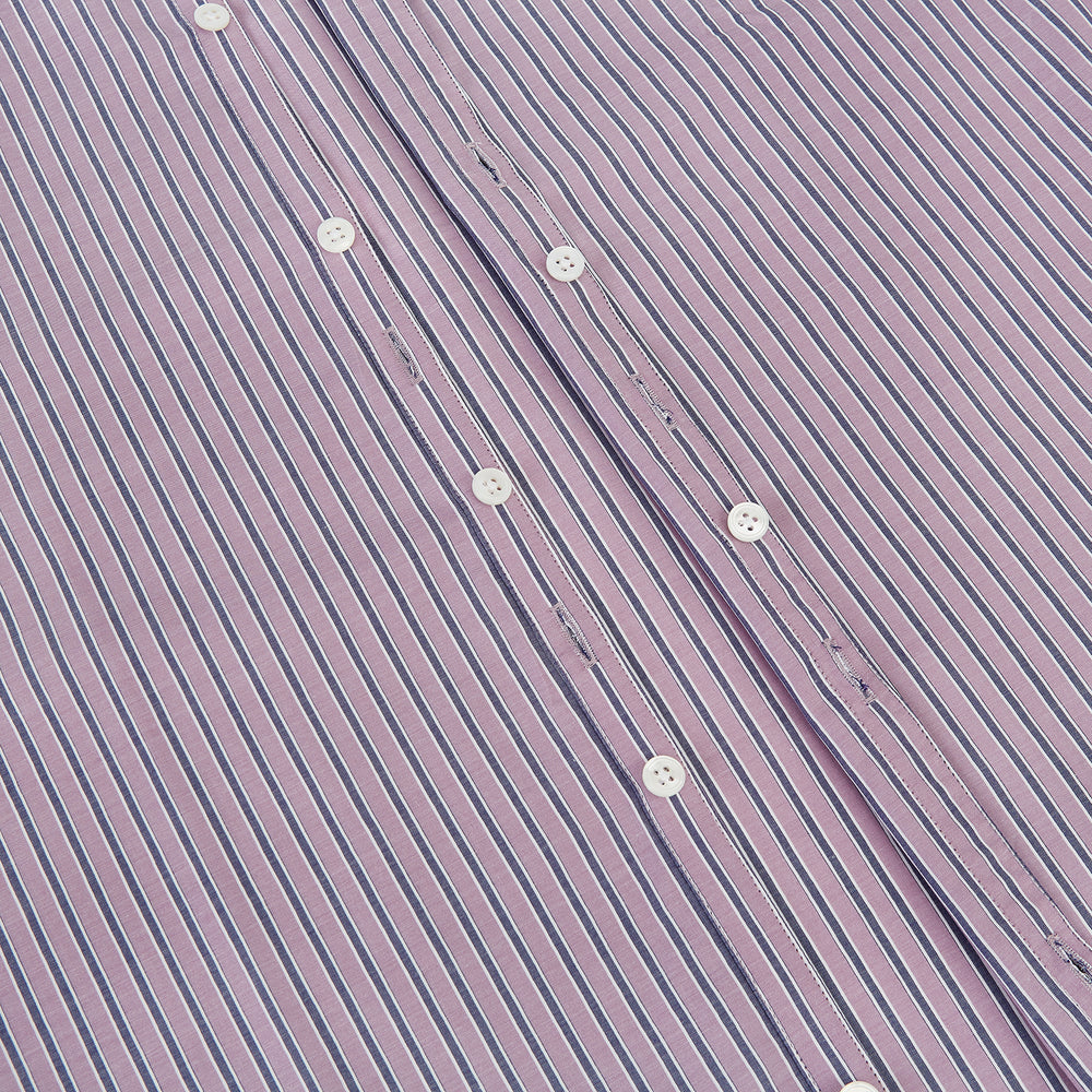 The Turnbull & Asser Antique Pink Ticking Stripe Westminster Shirt is a collared, long-sleeve button-up with thin vertical pink stripes on white, highlighting British craftsmanship. It’s shown neatly laid flat and fully buttoned.