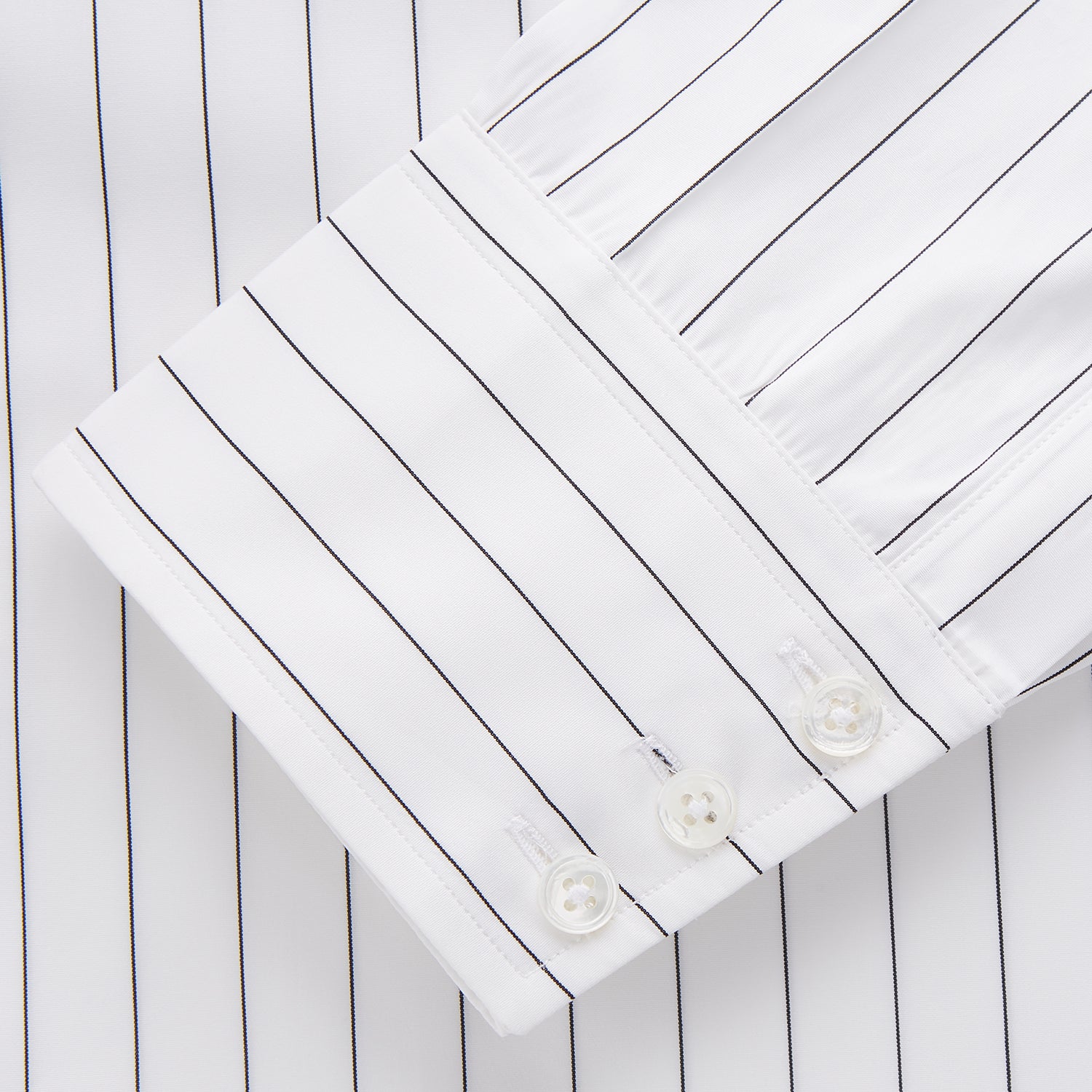 View 3 of product The Turnbull & Asser Black Fine Stripe Cotton Regular Fit Mayfair Shirt features a T&A collar, buttoned cuffs, and black fine stripes, displayed flat on a white background.