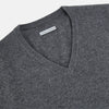 View 2 of product The Turnbull & Asser Storm Grey Cashmere V-neck Jumper features long sleeves, ribbed cuffs and hem—versatile knitwear shown on a white backdrop.