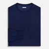 View 4 of product The Turnbull & Asser Navy Merino Round Neck Jumper is shown against a light gray background, featuring a classic long-sleeve design with ribbed cuffs, hem, and neckline for timeless style.