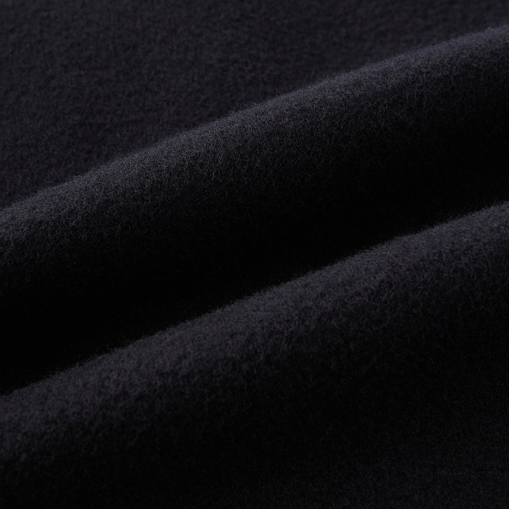 The Navy Apsley Single-Breasted Caban Coat by Turnbull & Asser features three buttons, notch lapels, a chest pocket, and two front flap pockets, shown against a plain light gray background.