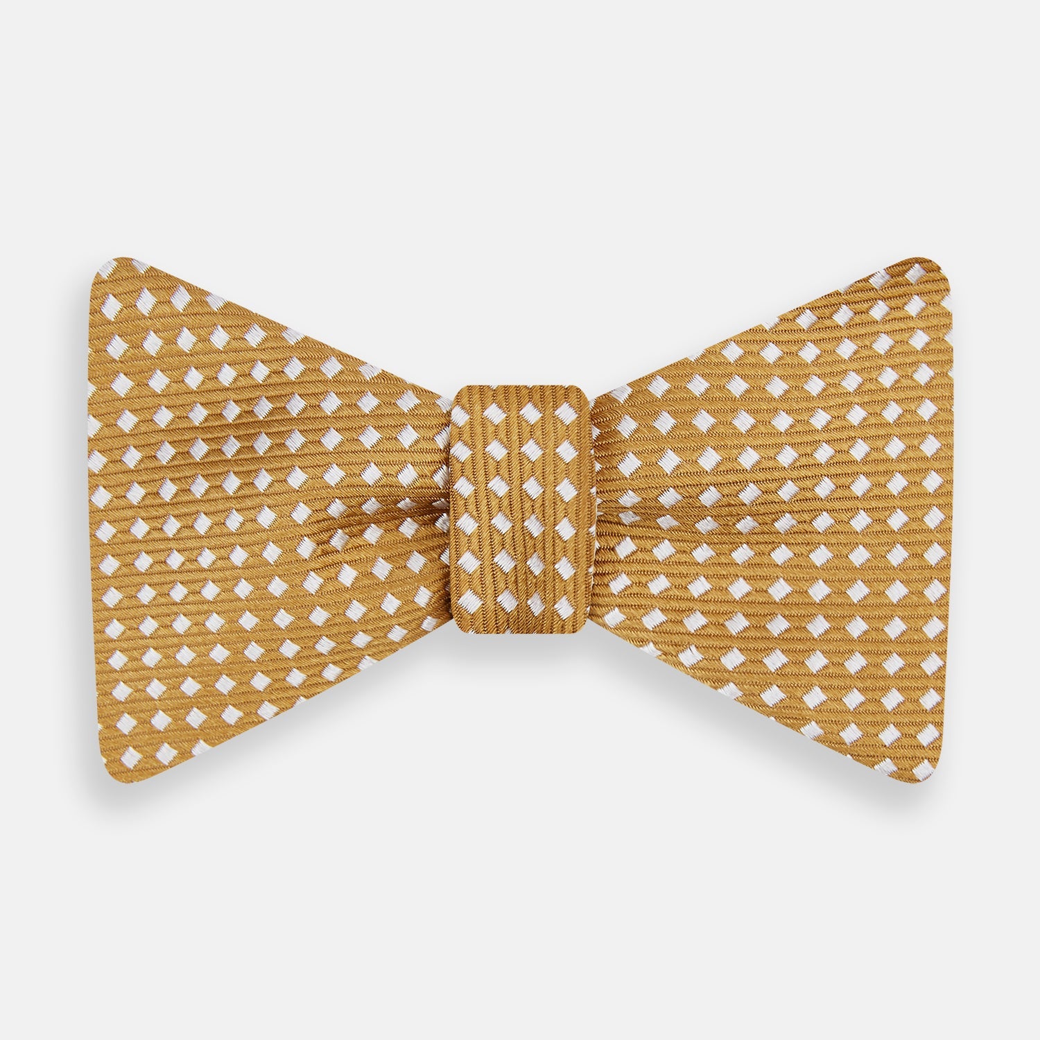View 1 of product The Turnbull & Asser Camel and White Diamond Silk Bow Tie features a ribbed texture with evenly spaced white diamond shapes, offering an elegant accessory for formalwear, shown on a white background.