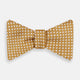 The Turnbull & Asser Camel and White Diamond Silk Bow Tie features a ribbed texture with evenly spaced white diamond shapes, offering an elegant accessory for formalwear, shown on a white background.