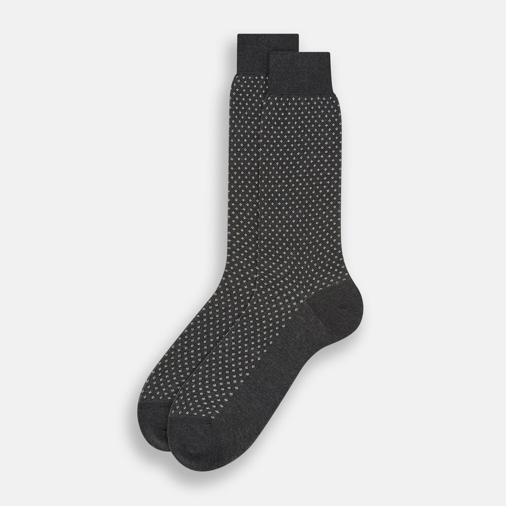 Turnbull & Asser Grey Motif Mid-Length Sock, crafted from Egyptian cotton, features a fine white geometric dot pattern on grey with a solid black cuff, heel, and toe for classic style. Displayed on a white background.