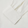 View 4 of product The Turnbull & Asser Cream Silk Tailored Fit Shirt is a long-sleeve button-up with a pointed collar and buttoned cuffs, displayed laid flat against a plain white background.