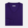 View 4 of product The Turnbull & Asser Purple Merino V-Neck Jumper features long sleeves and a rich, solid hue, making it an essential knitwear piece for any wardrobe.
