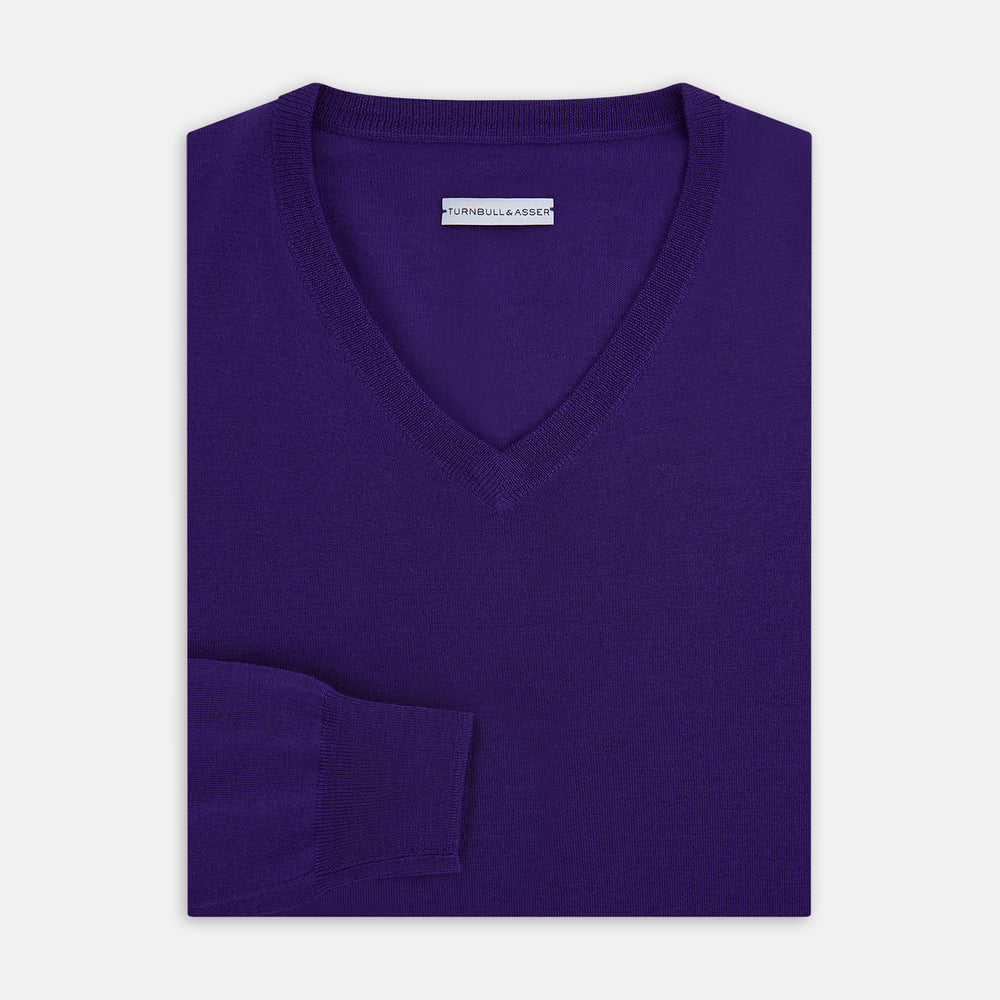 The Turnbull & Asser Purple Merino V-Neck Jumper features long sleeves and a rich, solid hue, making it an essential knitwear piece for any wardrobe.