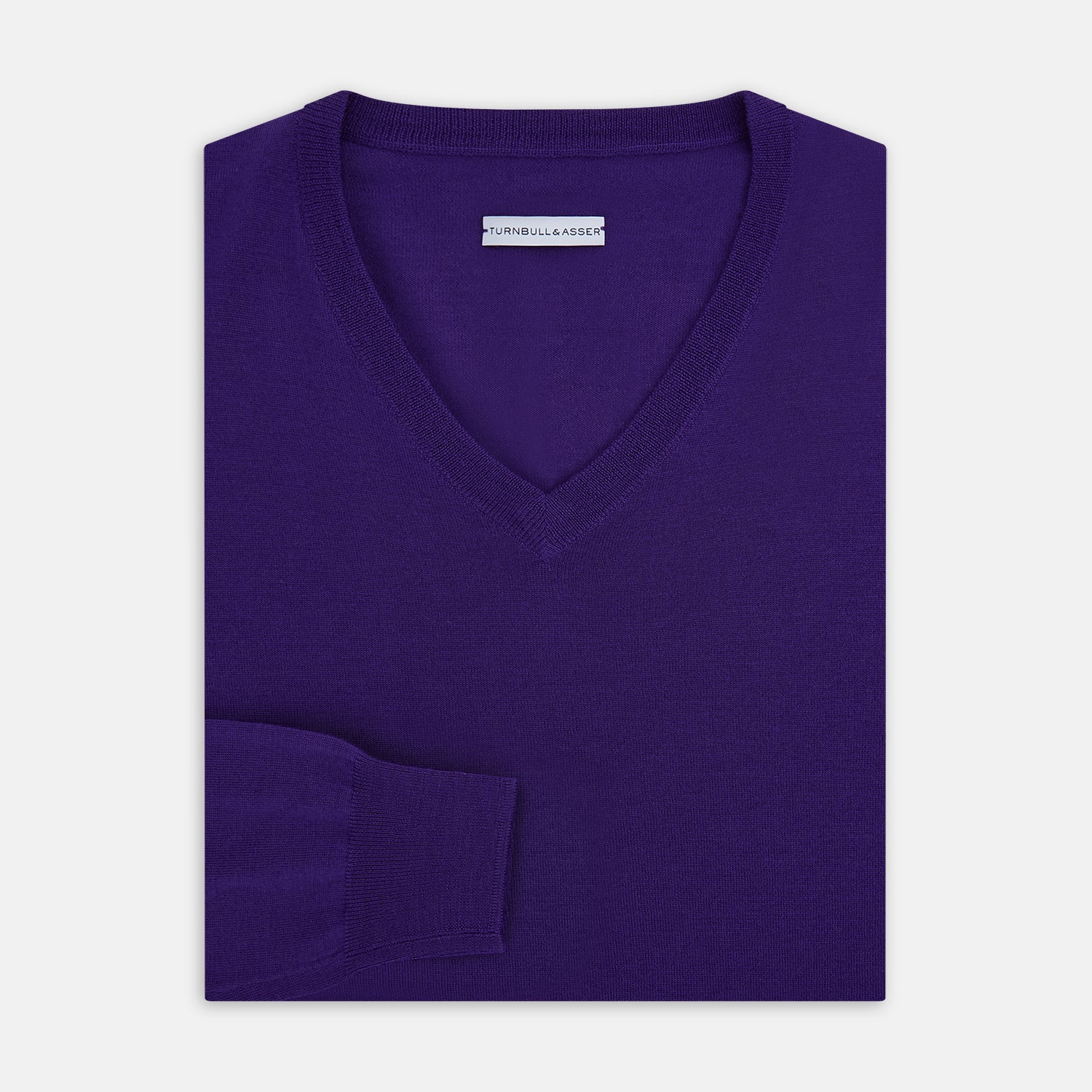 View 4 of product The Turnbull & Asser Purple Merino V-Neck Jumper features long sleeves and a rich, solid hue, making it an essential knitwear piece for any wardrobe.