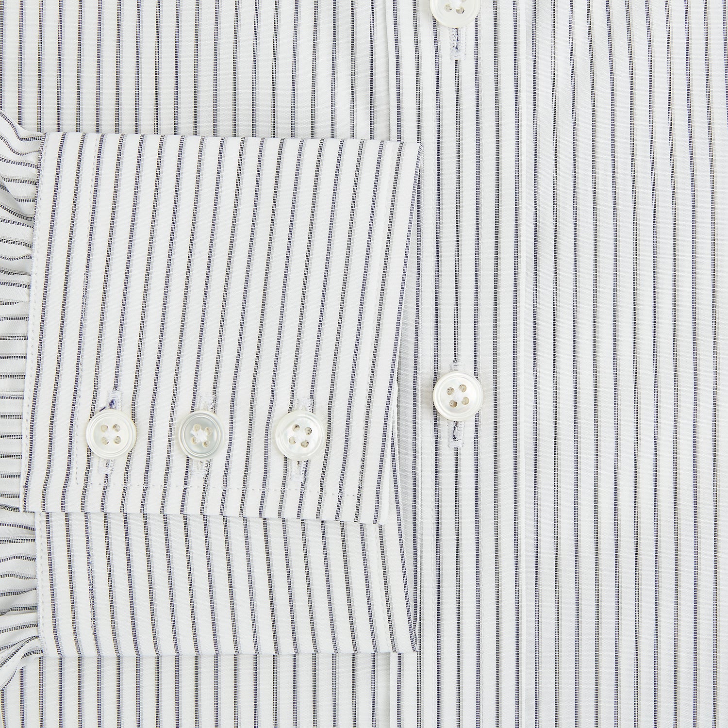 View 4 of product The Navy Music Stripe Mayfair Shirt by Turnbull & Asser features thin vertical blue and white stripes, a classic T&A collar, and long sleeves, shown on a plain white background.
