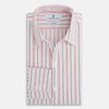 View 5 of product The Red Multi Pencil Stripe Windsor Shirt by Turnbull & Asser features long sleeves, buttoned cuffs, a Turnbull collar, and classic British tailoring with vertical red, pink, and white stripes.