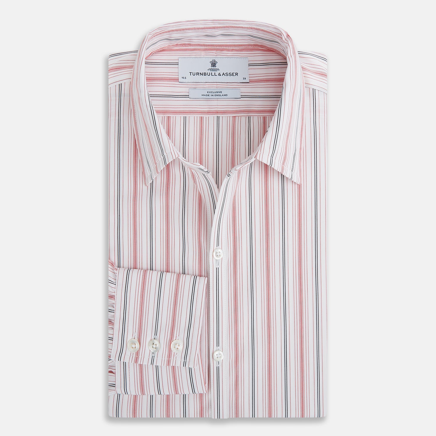 View 5 of product The Red Multi Pencil Stripe Windsor Shirt by Turnbull & Asser features long sleeves, buttoned cuffs, a Turnbull collar, and classic British tailoring with vertical red, pink, and white stripes.