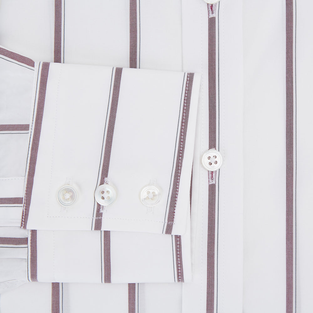 The Turnbull & Asser Wine Track Stripe Mayfair Shirt is a white long-sleeve shirt with vertical wine stripes and a pointed collar, crafted from premium Italian cotton and shown flat against a plain background.