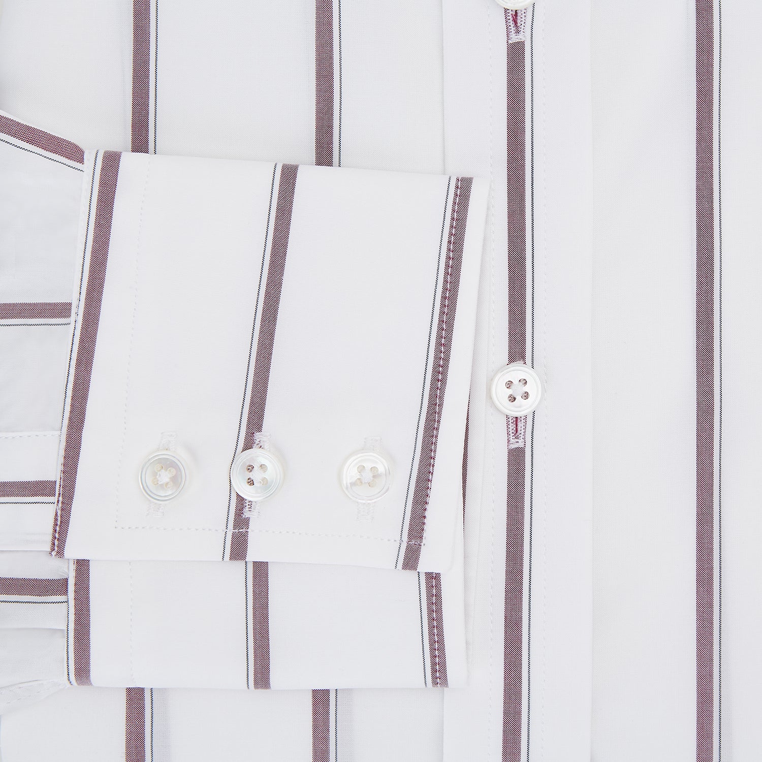 View 4 of product The Turnbull & Asser Wine Track Stripe Mayfair Shirt is a white long-sleeve shirt with vertical wine stripes and a pointed collar, crafted from premium Italian cotton and shown flat against a plain background.