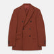 The Turnbull & Asser Rust Linen-Wool-Silk Bertie Blazer is a red double-breasted jacket with peak lapels, black buttons, and flap pockets, tailored in Italy from a luxury linen-wool-silk blend and shown on a white background.