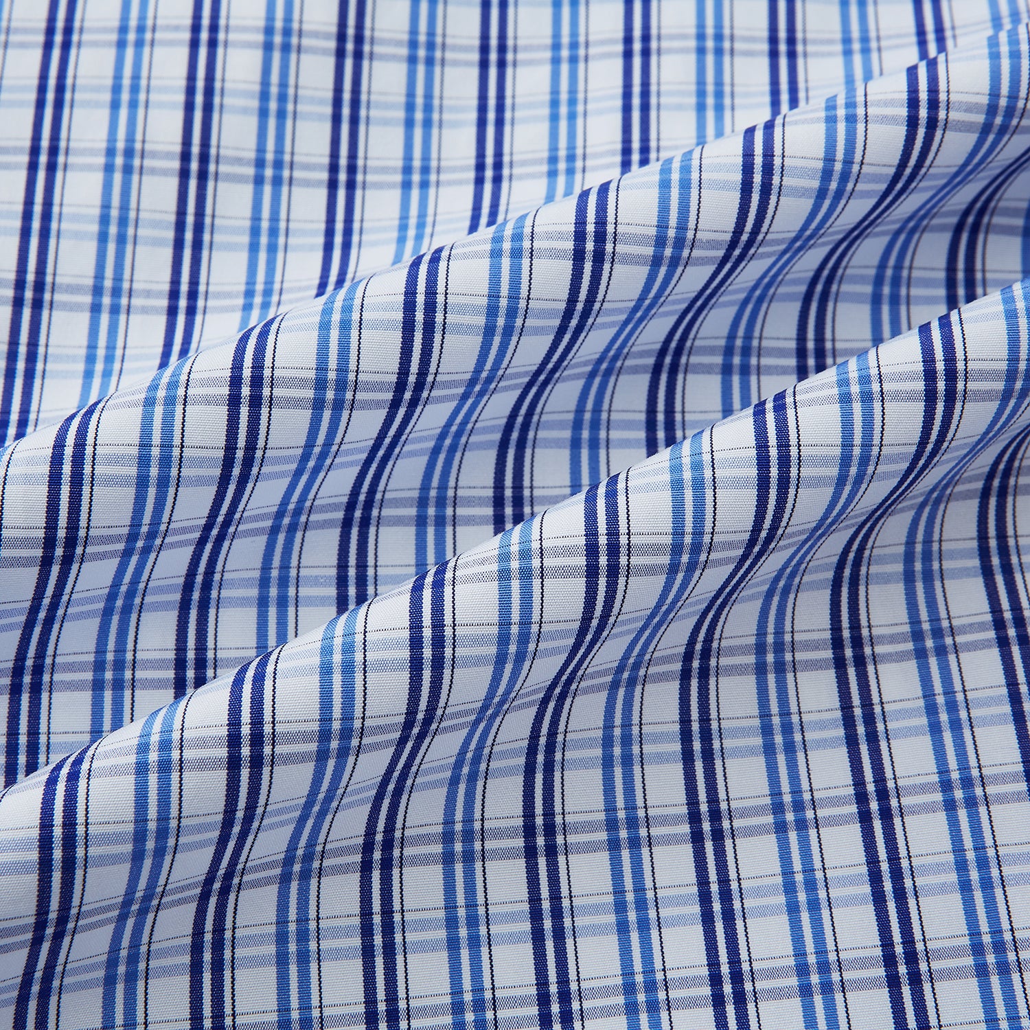 View 6 of product Turnbull & Asser's Blue and Navy Multi Check Piccadilly Shirt features long sleeves, a pointed collar, and two buttoned chest pockets, shown on a white background.