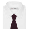View 2 of product The Turnbull & Asser MTIE011-ZAI003 TIES 7.5CM is a plain burgundy tie shown rolled on a white background, featuring straight edges and textured knit—ideal for the modern gentleman’s versatile wardrobe.