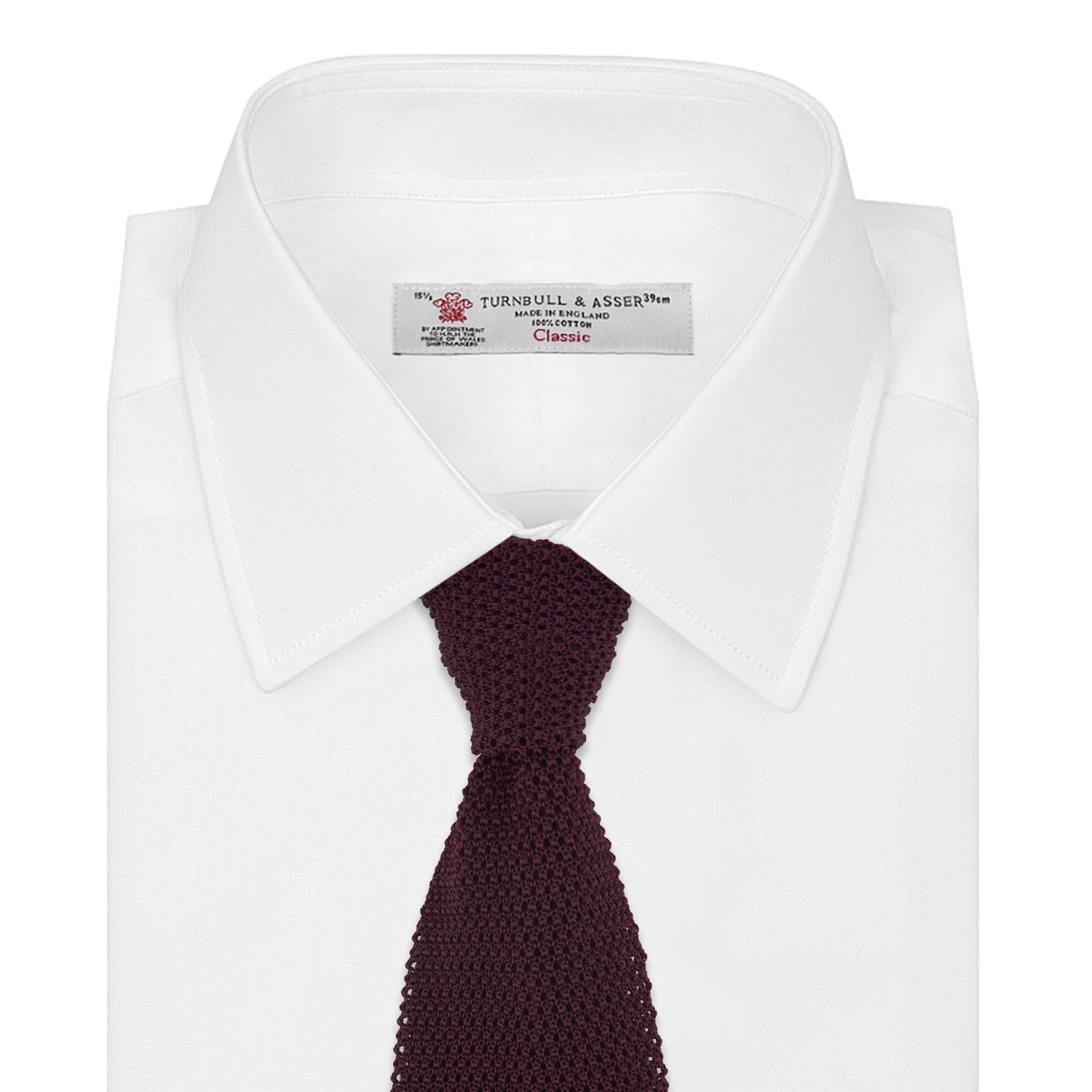 View 2 of product The Turnbull & Asser MTIE011-ZAI003 TIES 7.5CM is a plain burgundy tie shown rolled on a white background, featuring straight edges and textured knit—ideal for the modern gentleman’s versatile wardrobe.
