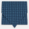 View 1 of product The Turnbull & Asser Dark Navy Floral Tile Pattern Printed Silk Cravat features a British-inspired light blue floral tile design, elegantly displayed on a white background.