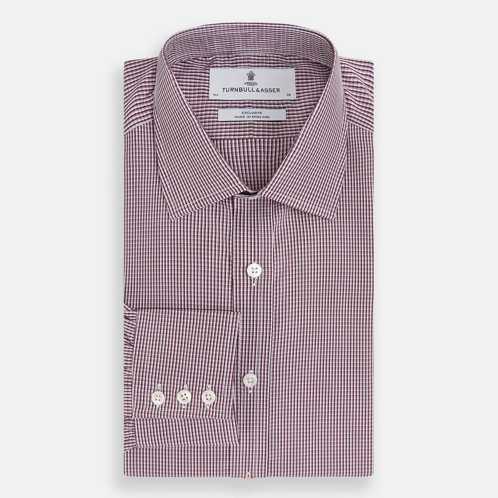 The Turnbull & Asser Burgundy Micro Check Mayfair Shirt features long sleeves, a pointed collar, and white buttons—perfect for formal wear. Shown laid flat on a white background.