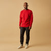 View 2 of product The Red Lewis Guernsey Knitted Jumper by Turnbull & Asser is a bright red wool-cotton, long-sleeve jumper with a round neckline, ribbed cuffs, and ribbed hem, shown against a white background.