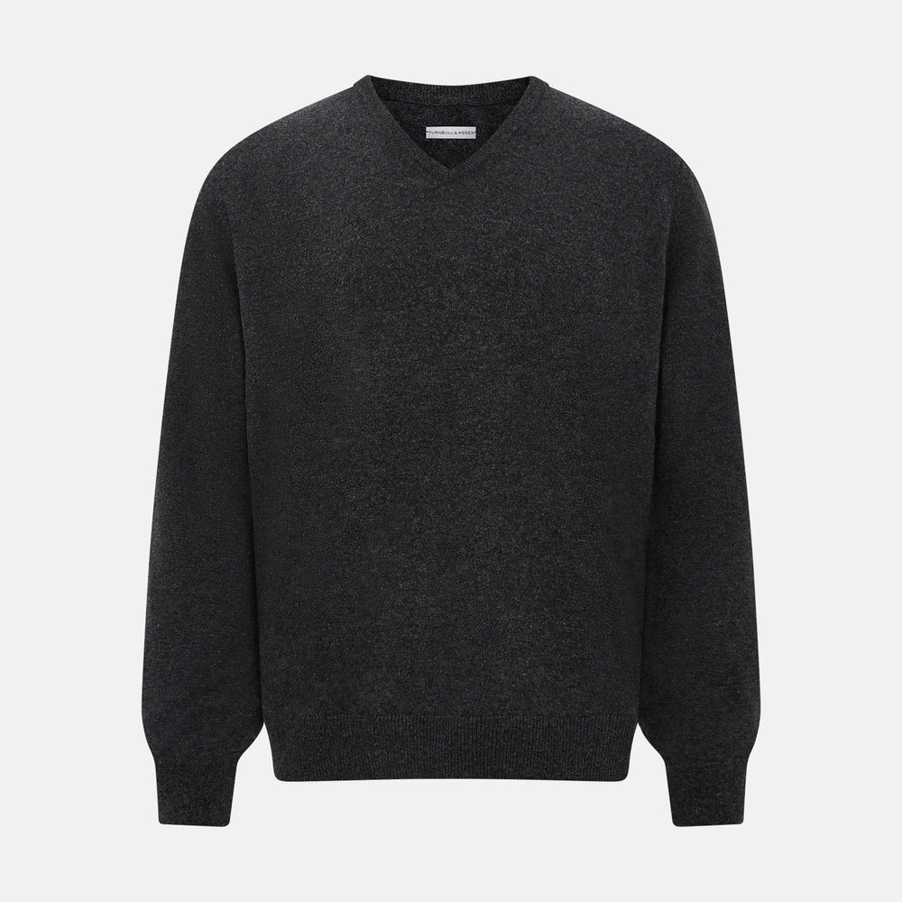 The Turnbull & Asser Charcoal Grey Melange V-Neck Cashmere Jumper is shown on a white background, featuring long sleeves, ribbed cuffs and hem for classic style and comfort.