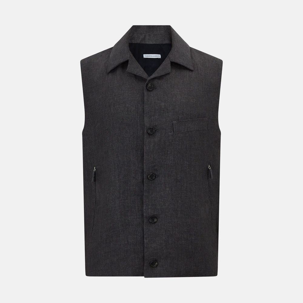 The Turnbull & Asser Ash Collared Linen Waistcoat is a sleeveless dark gray piece with a button-down front, two zippered side pockets, and a small chest pocket, shown against a plain white background.