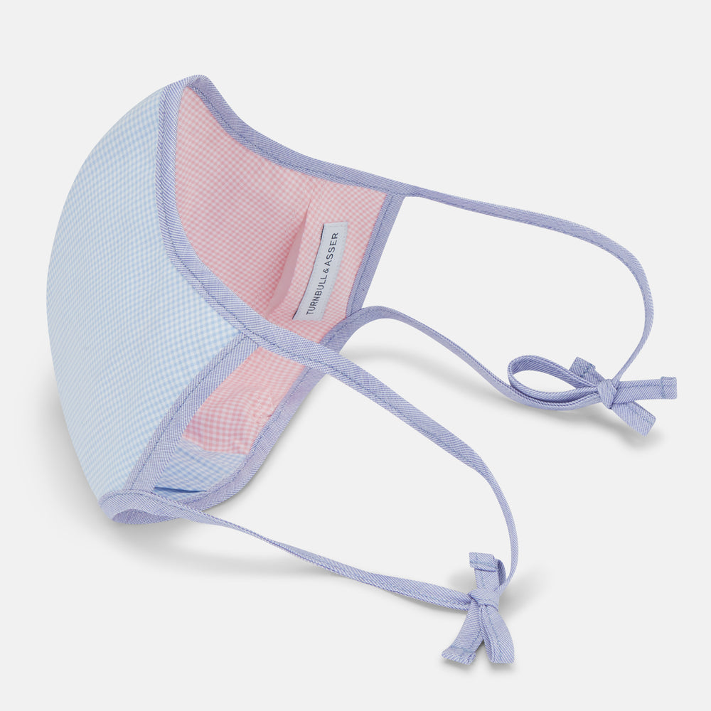 The Turnbull & Asser Pink & Blue Check Commuter Mask features lavender adjustable ear loops tied in bows and comes with 3 Viroformula™ filters. Shown on a plain white background.