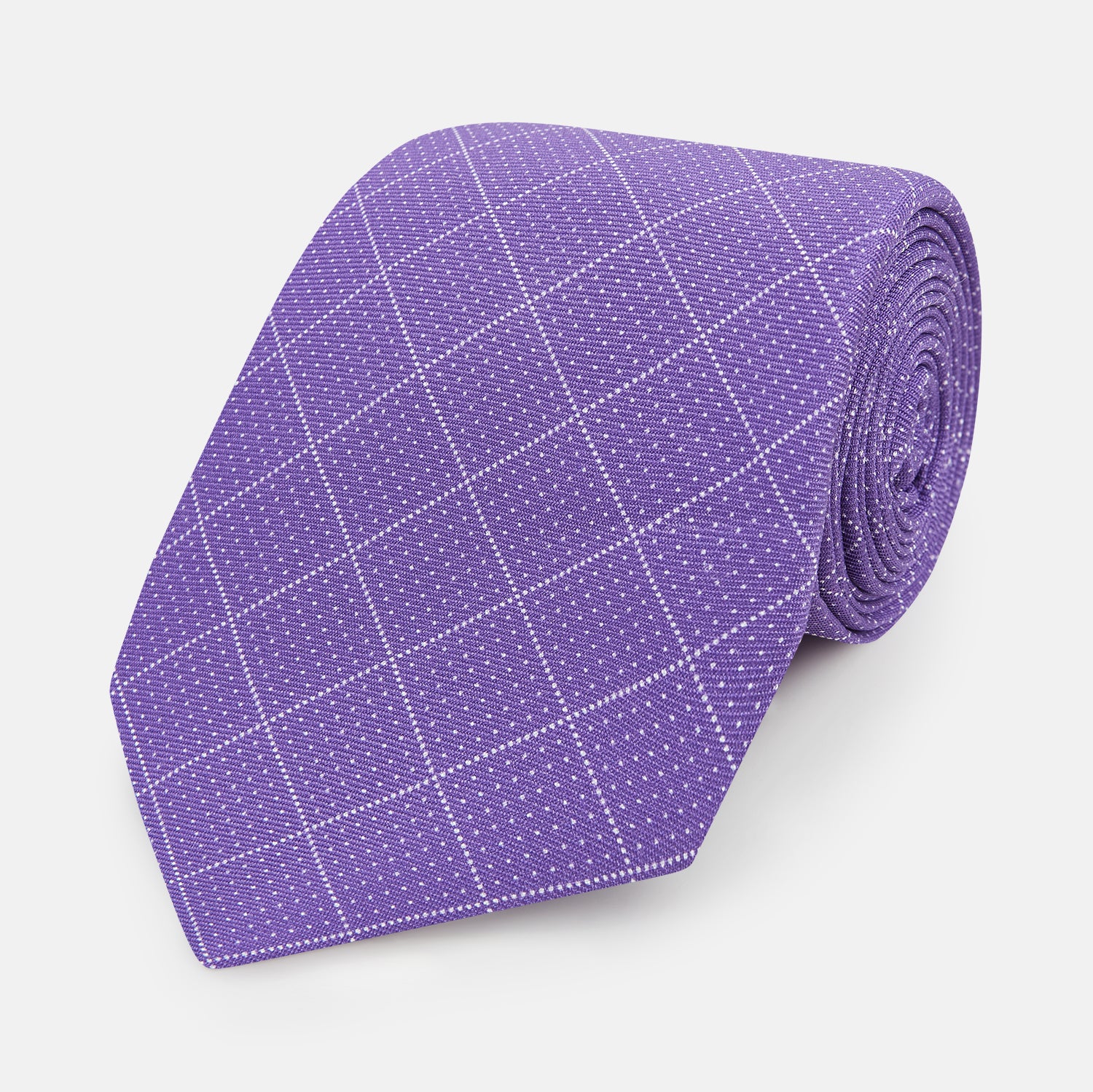 View 1 of product The Turnbull & Asser Purple Dotted Check Pattern Printed Silk Tie is displayed rolled up on a white background, featuring a subtle check design for an elegant look.