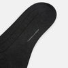 View 3 of product A Charcoal Dash Striped Mid-Length Sock from Turnbull & Asser is shown on a plain white background, positioned to emphasize its ribbed texture and length.