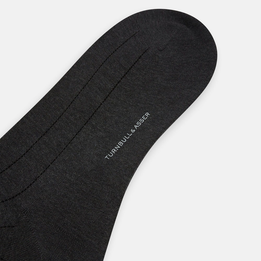 A Charcoal Dash Striped Mid-Length Sock from Turnbull & Asser is shown on a plain white background, positioned to emphasize its ribbed texture and length.