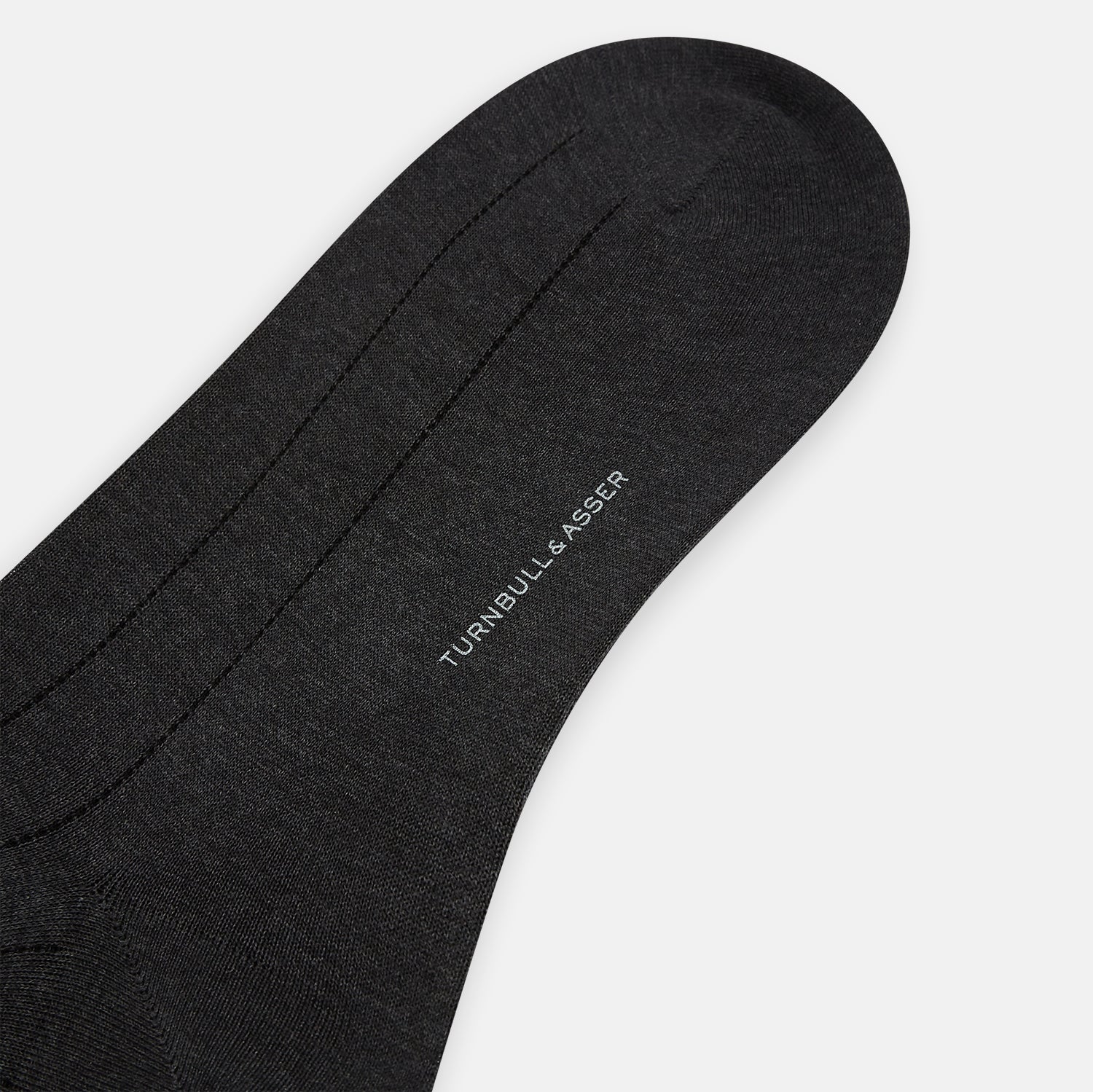 View 3 of product A Charcoal Dash Striped Mid-Length Sock from Turnbull & Asser is shown on a plain white background, positioned to emphasize its ribbed texture and length.