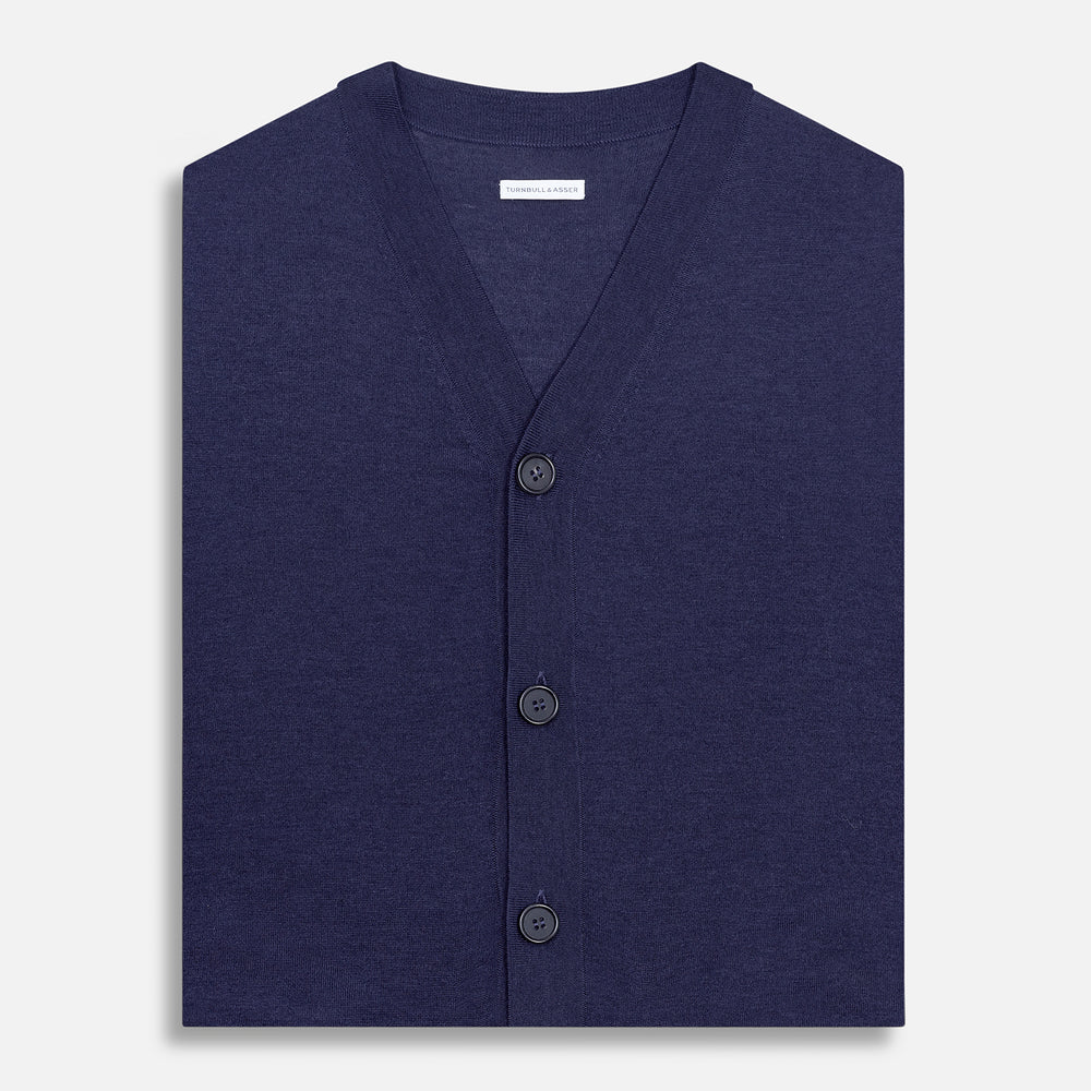 The Turnbull & Asser Navy Fine Merino V-Neck Sleeveless Cardigan features a front button closure, ribbed hem, and two pockets—sophisticated knitwear shown on a plain white background.