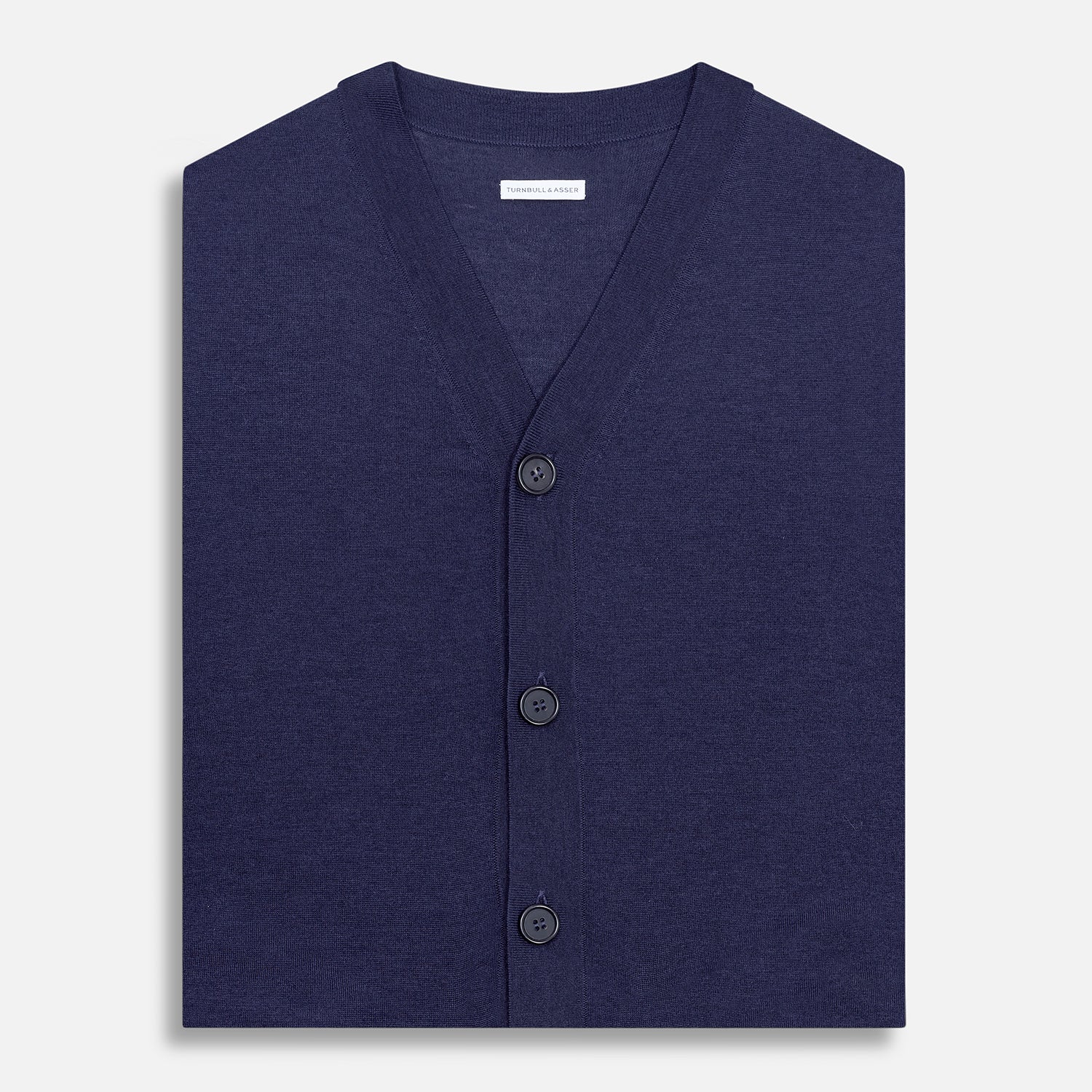 View 4 of product The Turnbull & Asser Navy Fine Merino V-Neck Sleeveless Cardigan features a front button closure, ribbed hem, and two pockets—sophisticated knitwear shown on a plain white background.