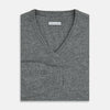 View 4 of product The Turnbull & Asser Grey Melange Cashmere V-neck Jumper features long sleeves, ribbed cuffs and hem, showcasing timeless style against a white background.