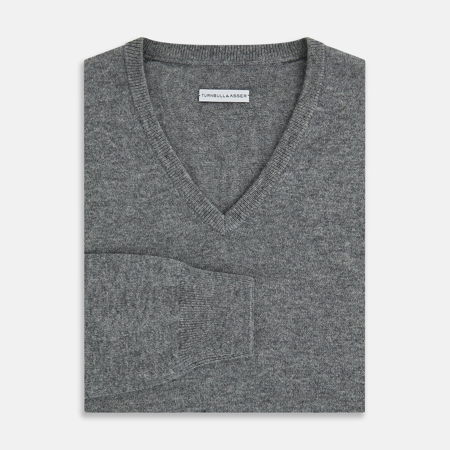 View 4 of product The Turnbull & Asser Grey Melange Cashmere V-neck Jumper features long sleeves, ribbed cuffs and hem, showcasing timeless style against a white background.