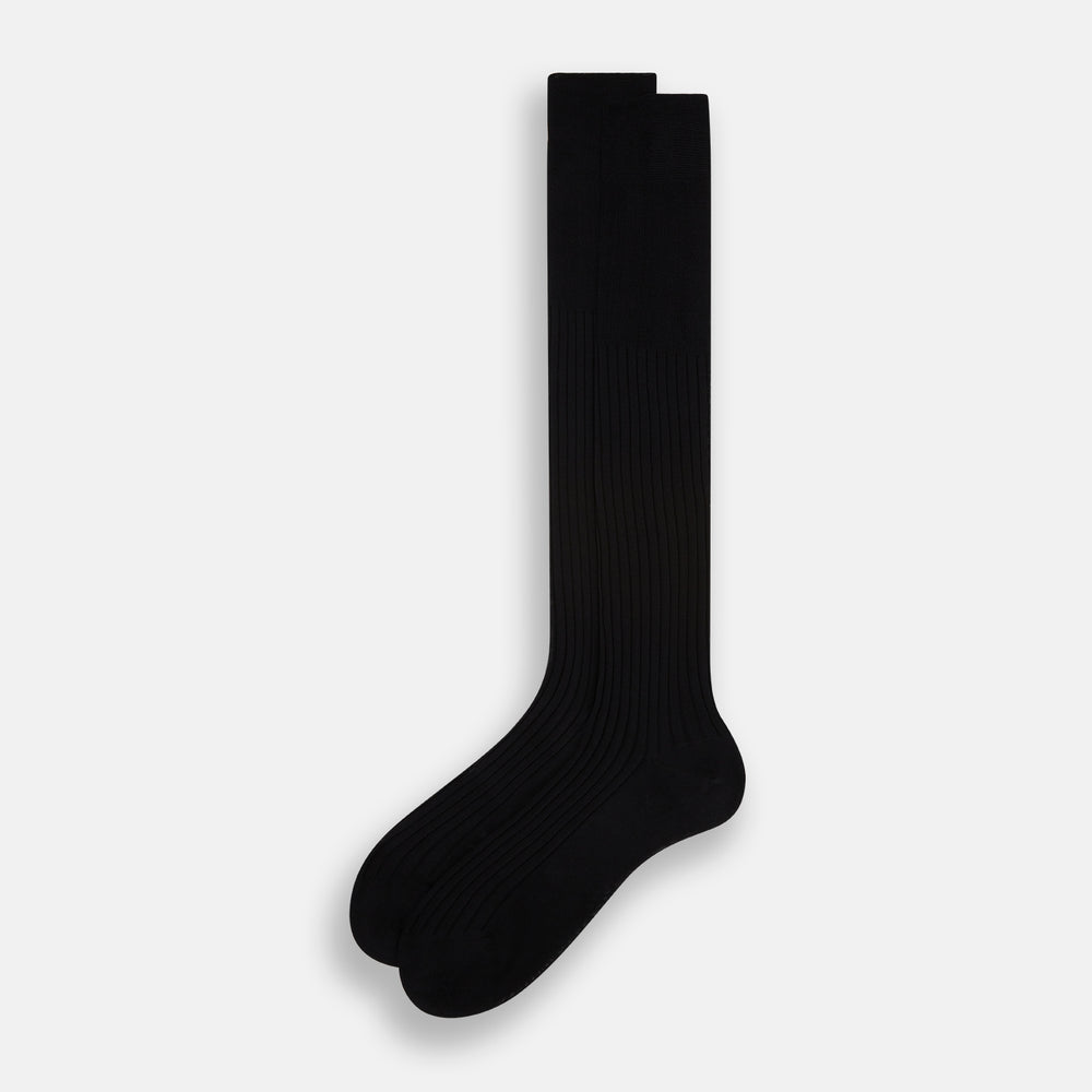 A single Turnbull & Asser Black Cotton Long Sock is shown upright on a white background, featuring a ribbed texture along the leg and foot with a smooth finish at the top.
