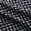 View 4 of product The Turnbull & Asser Black Multi Check Cotton Blend Weekend Fit Hayne Shirt features a Dorset button-down collar and white buttons, with a black and white plaid pattern, shown laid flat on a white background.